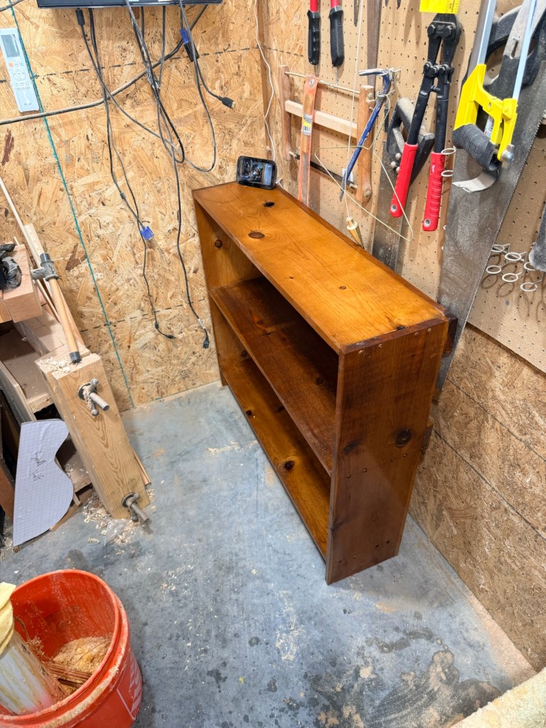 Book shelf in corner of workshop